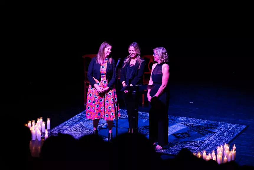 Three women perform onstage.