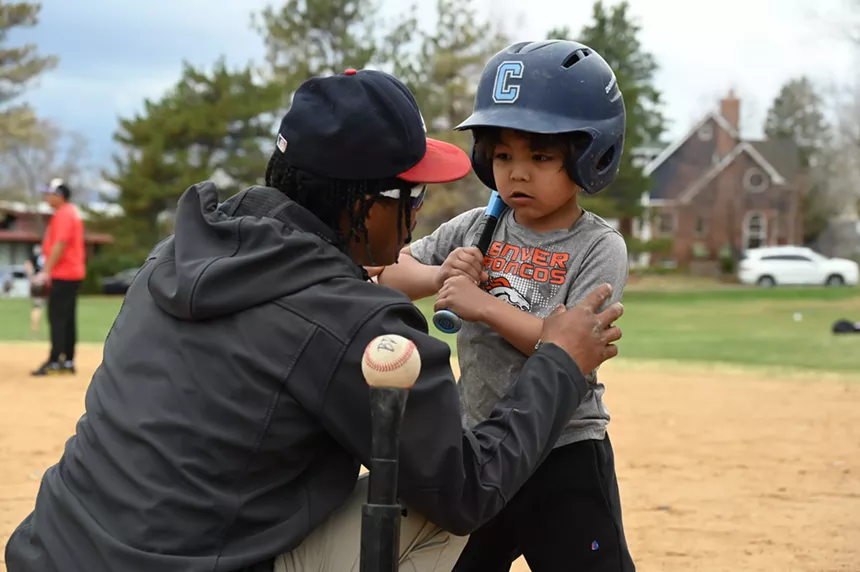 A man coaches a kid.