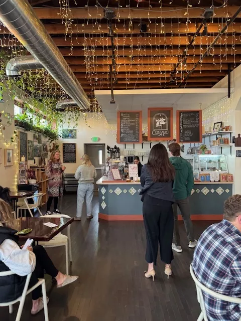 People stand in line at a coffee shop
