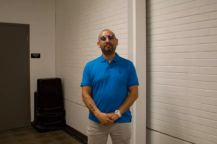 Man with sunglasses poses for photo