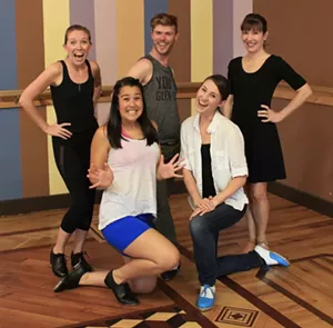 A team of dancers poses for the camera.
