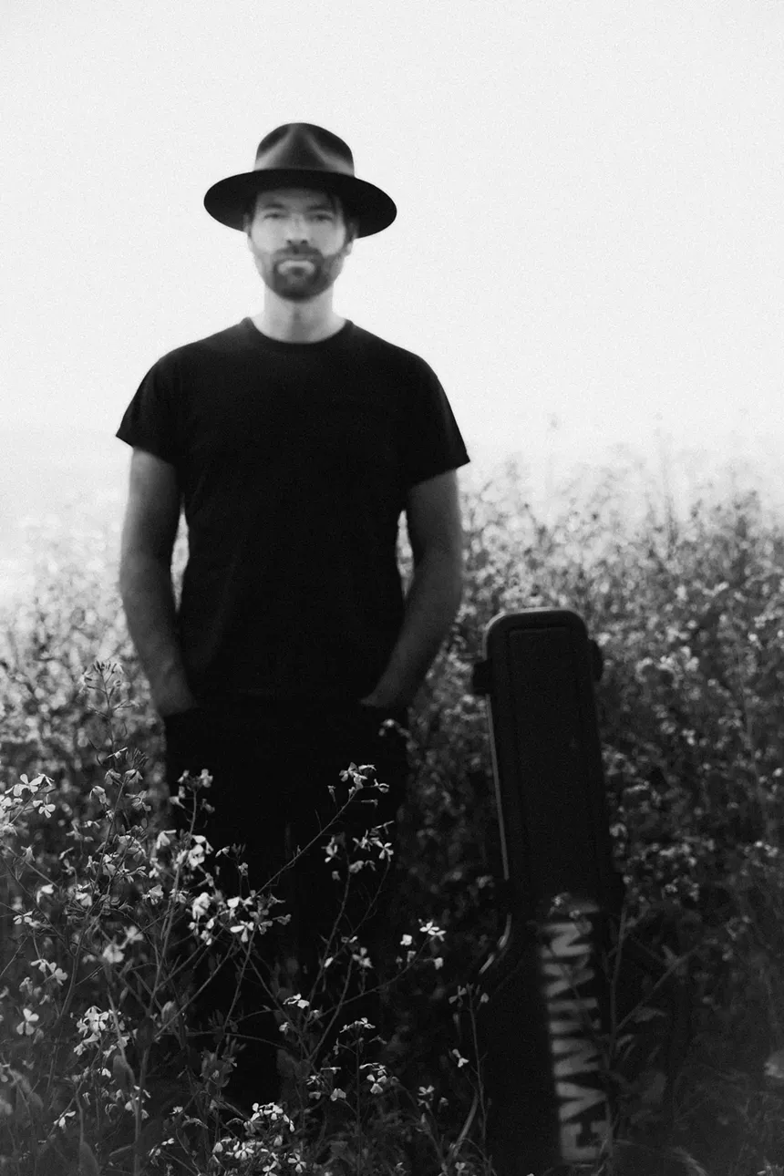 man in a black t-shirt and hat