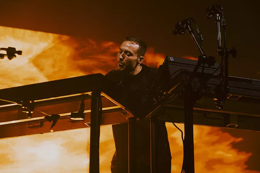 A photo of Ben Böhmer performing on stage at his DJ station.