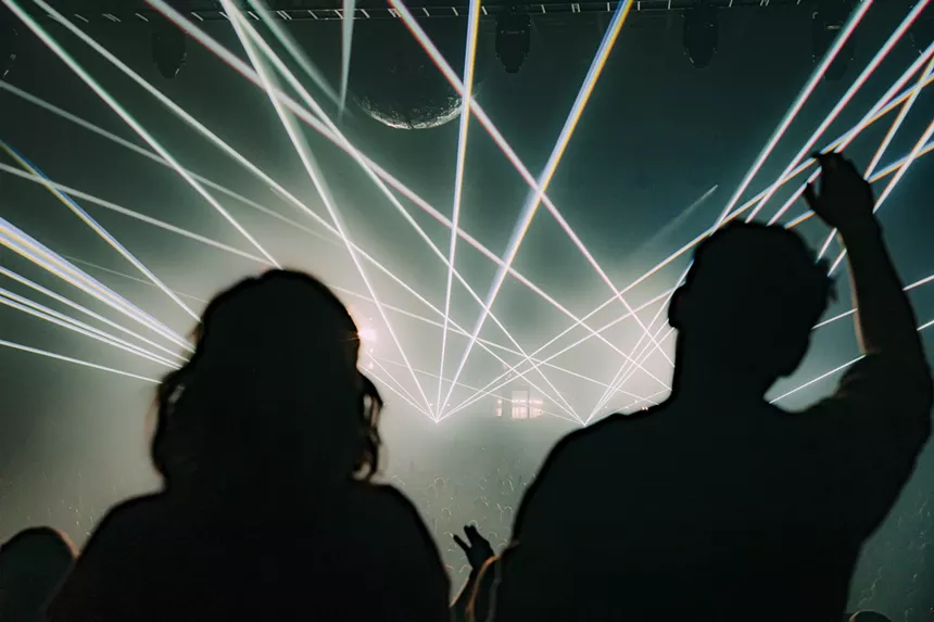 A photo of a couple looking at lasers during a concert.