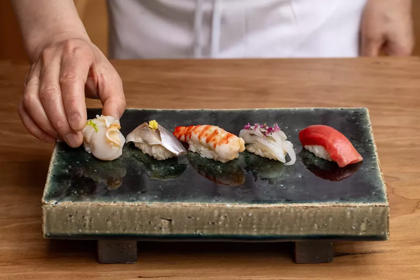 sushi on a black plate