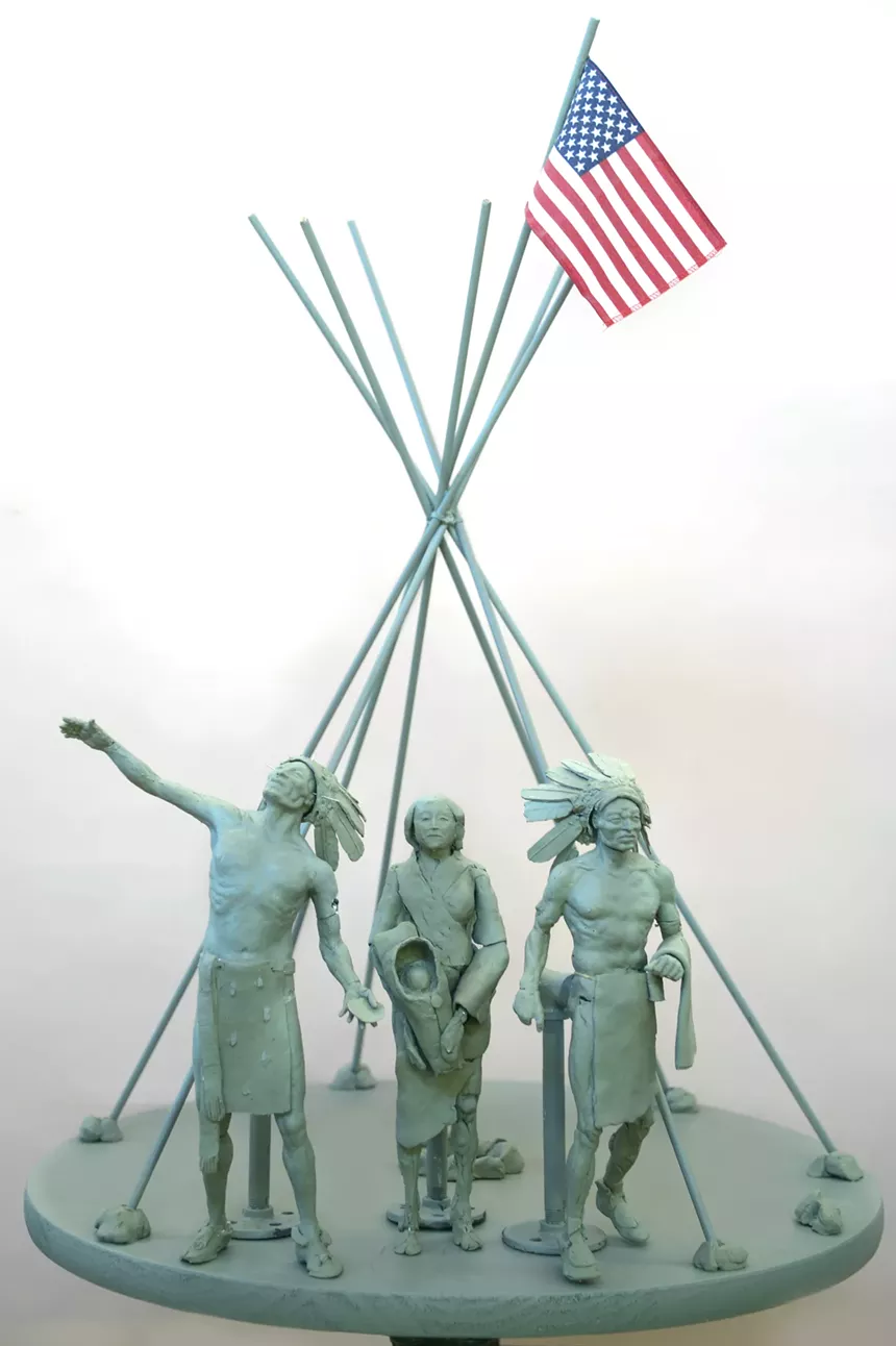 statue with Indigenous chiefs and woman and child.