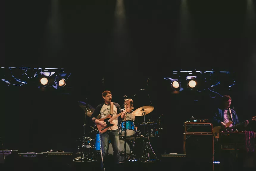 Sturgill Simpson performing on stage at Mission Ballroom with his drummer behind him.