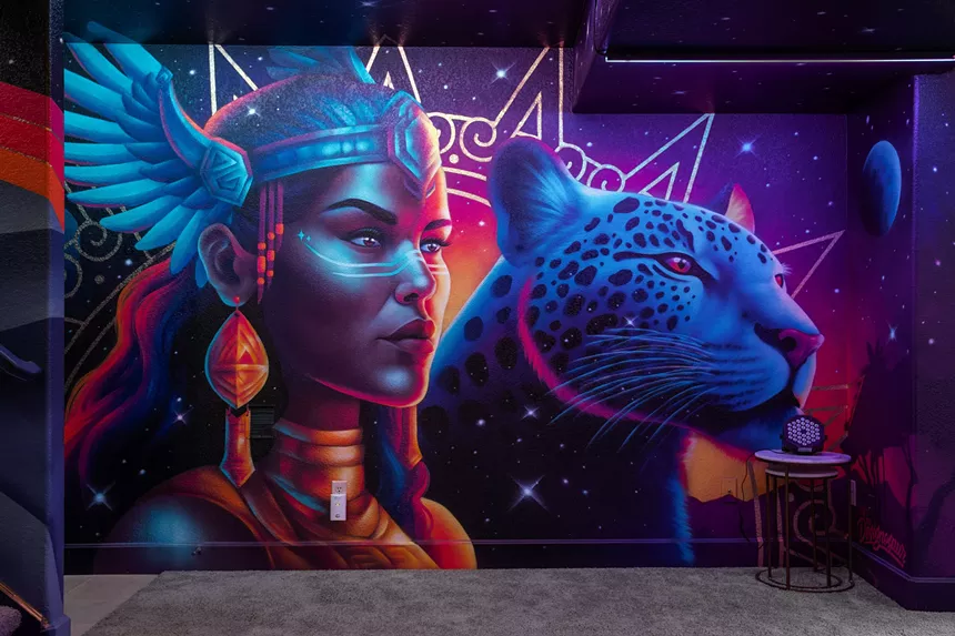 A colorful mural of a woman and cheetah
