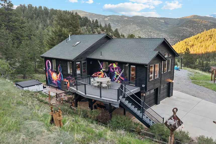 A house with colorful murals in the mountains