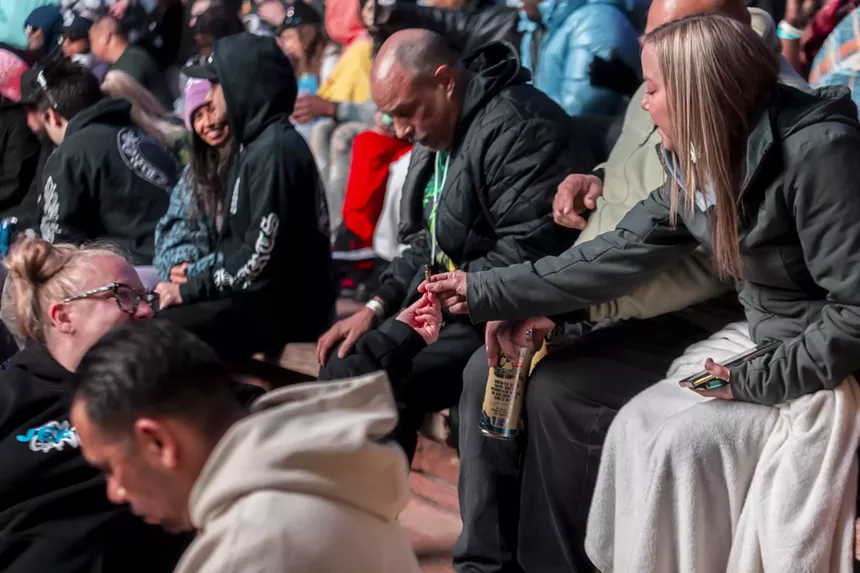 Fans pass a joint before Wiz Khalifa's performance at Red Rocks.