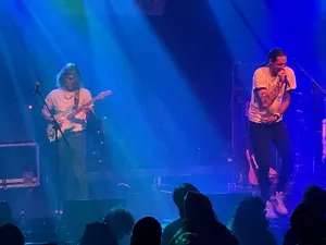 duo on blue stage.
