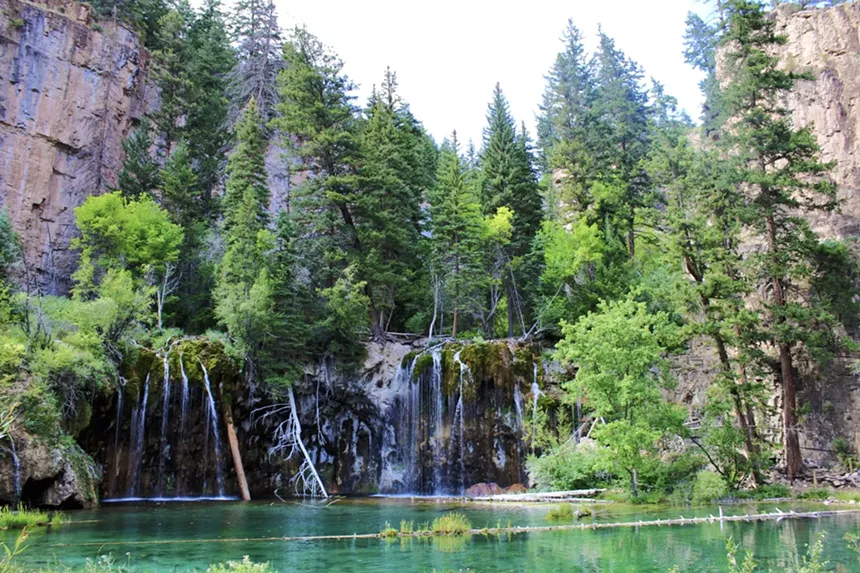 Evergreen trees and canyon walls surrounding Hanging Lake