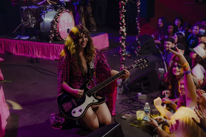 A photo showing Demi Demitro engaging with the crowd at the Bluebird Theatre.