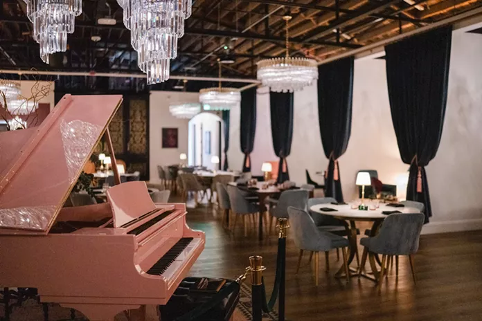 A pink grand piano within Cirrus Social Club's upscale interior