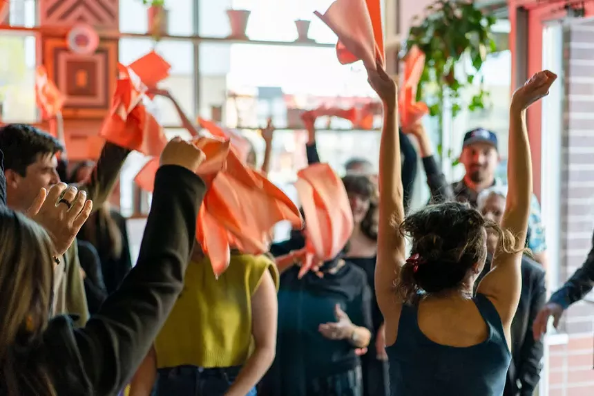 People wave napkins in the area.