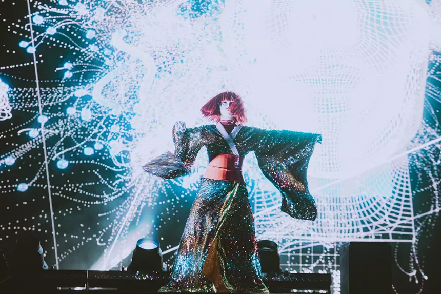 A photo of a stage performer dressed in an elaborate costume.