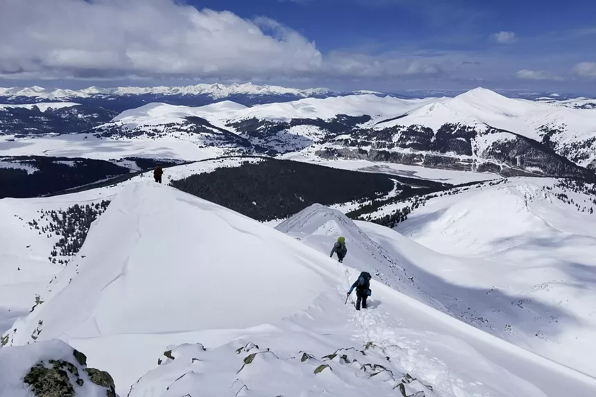 A group of alpinists climbing up snowy Atlantic Peak