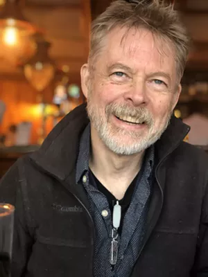 A portrait of a smiling man