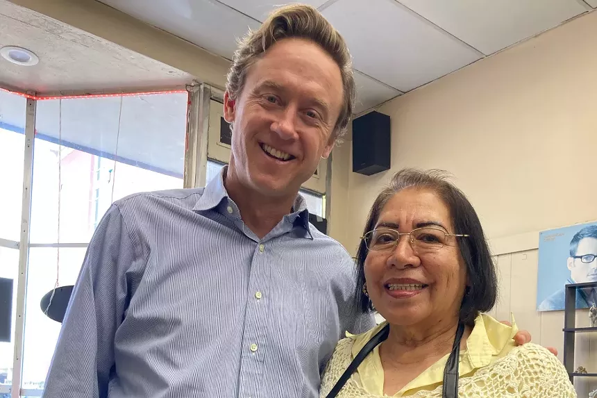A man and woman smile.