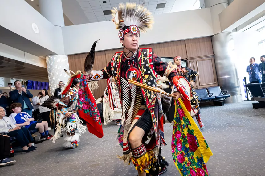 A traditional Native American dancer performing during the grand opening event at DIA