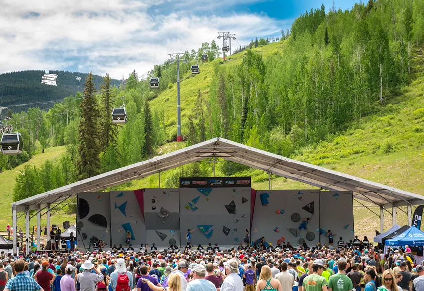 Athletes competing on an outdoor climbing wall during the GoPro Mountain Games