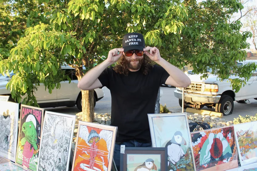 A man wears a hat that says "Keep Santa Fe Free"