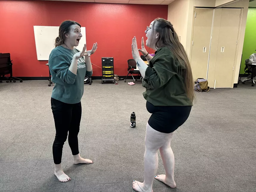 Two people mirror each other.