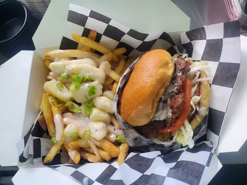 burger with fries topped with curds