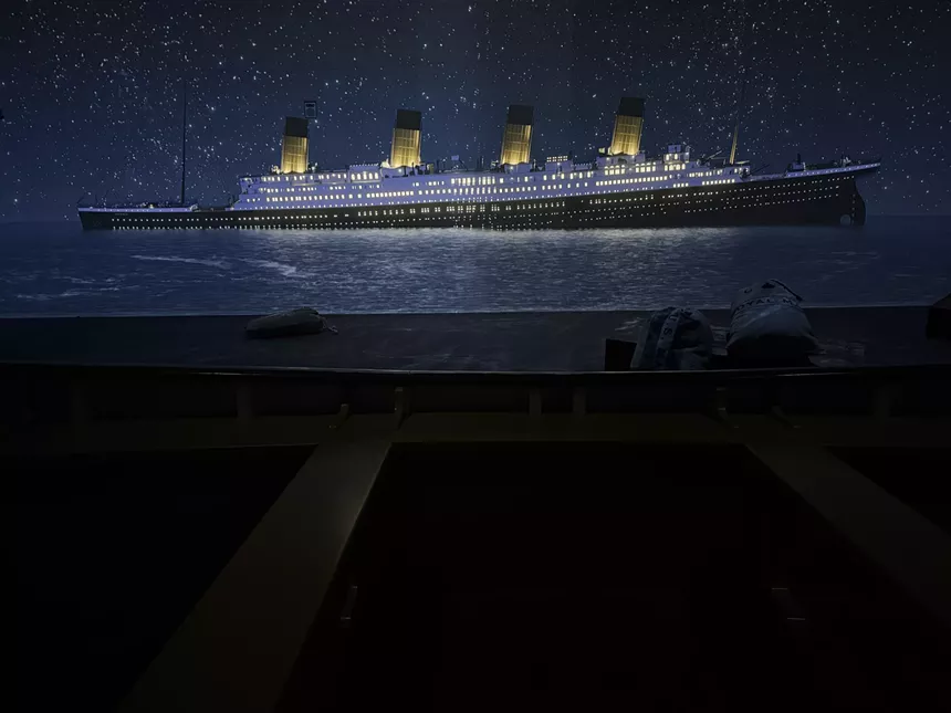 The Titanic sinks on a dark screen