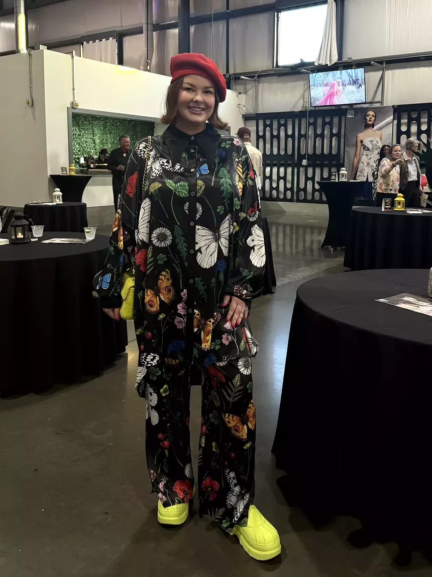 A woman in a red hat and black outfit