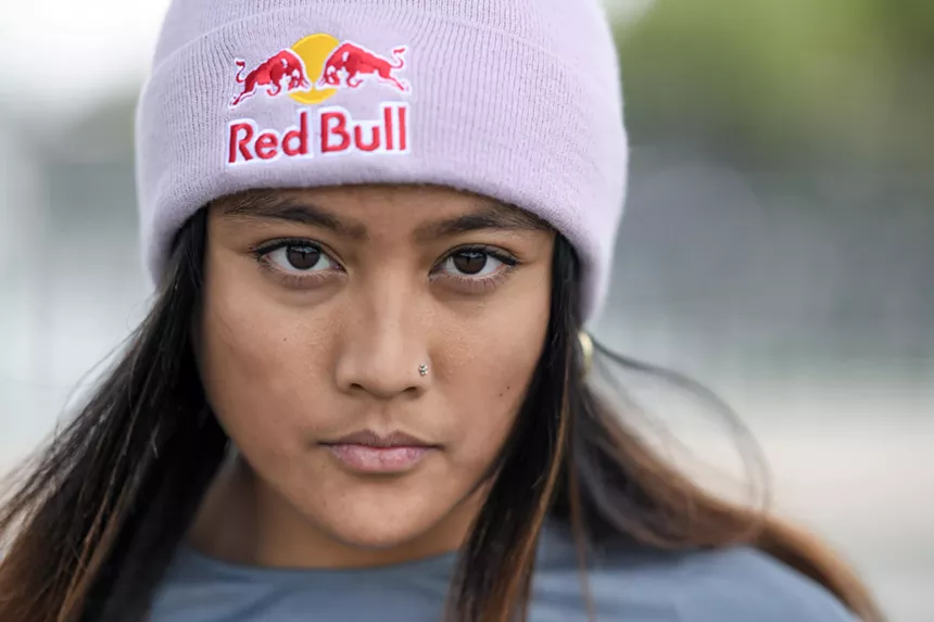 A woman wearing a Red Bull beanie.