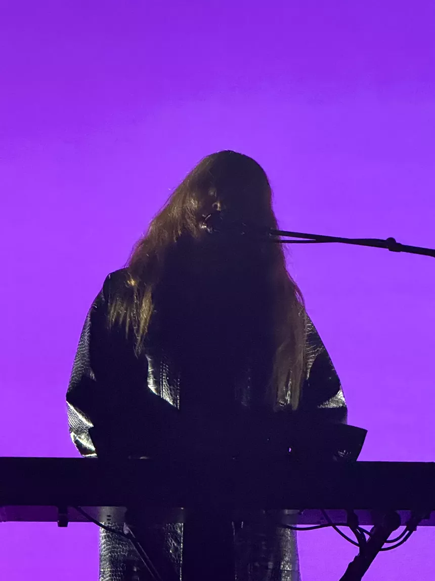 A figure at a synthesizer