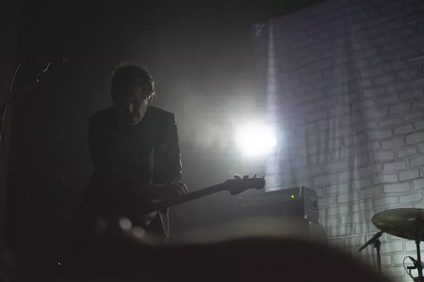 A silhouette of a bass player