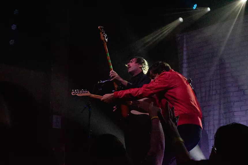 Guitar and bass players performing on stage