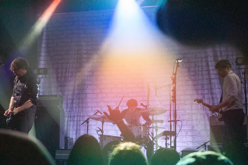 A band plays on-stage with colorful lighting