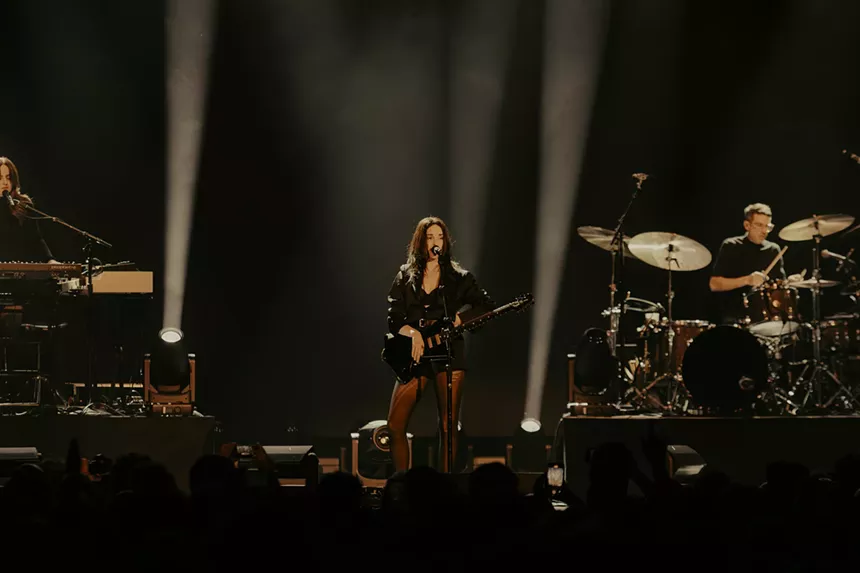 St. Vincent on stage with spotlights around her.