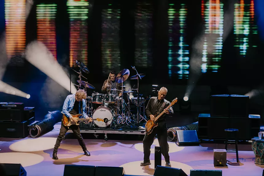 Sting performing on stage at Red Rocks.