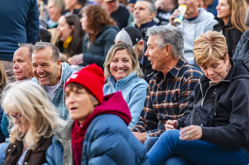 A photo of fans smiling while waiting for Sting at Red Rocks.