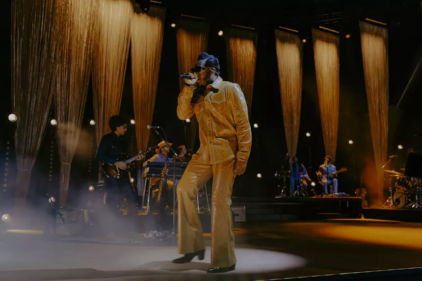 Leon Bridges performing on stage at Red Rocks.