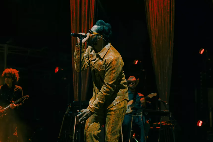 A photo showing Leon Bridges performing on stage at Red Rocks.