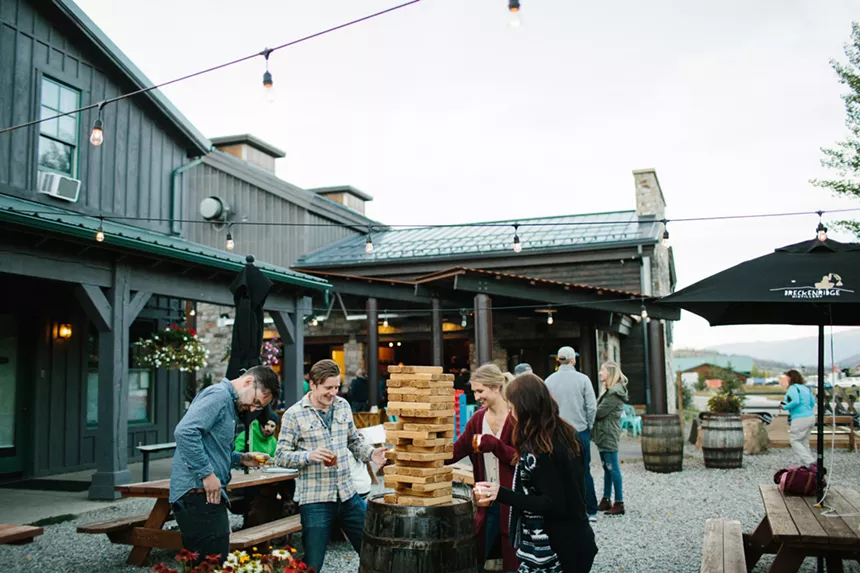 A group playing giant Jenga on Breckenridge Distillery's patio
