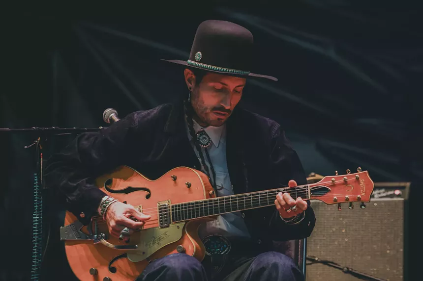 A photo of Hermanos Gutiérrez performing at Red Rocks.