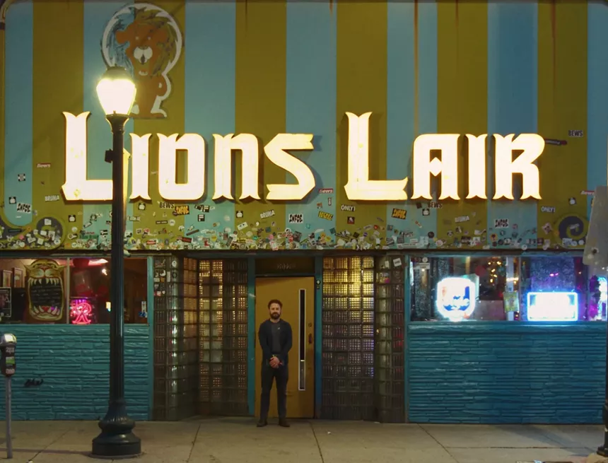 Adam Cayton-Holland standing in front of the Lion's Lair