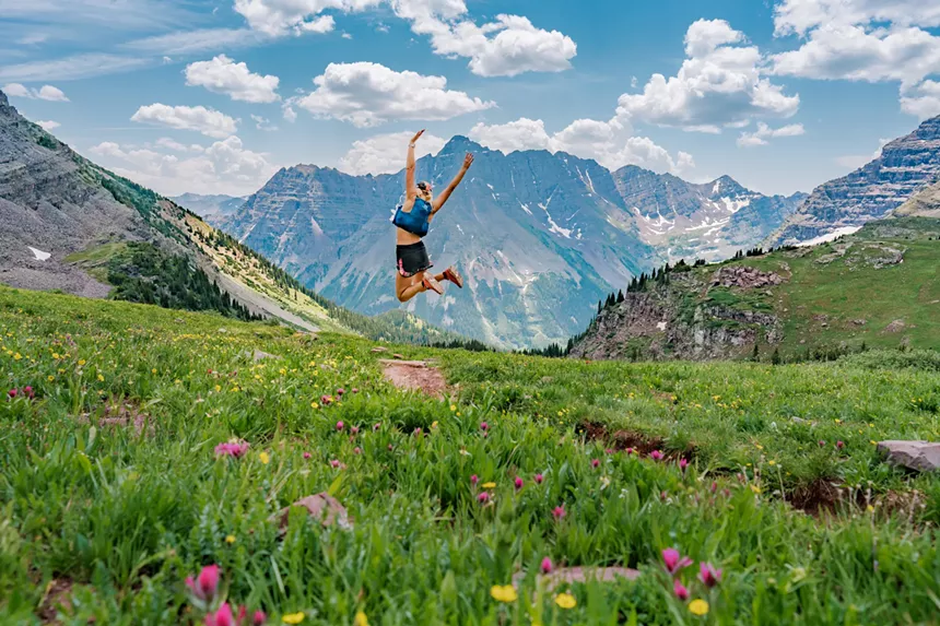 A person backdropped by a summer mountain scene in Aspen
