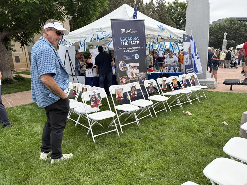 Empty chairs feature photos of hostages still held by Hamas in Gaza