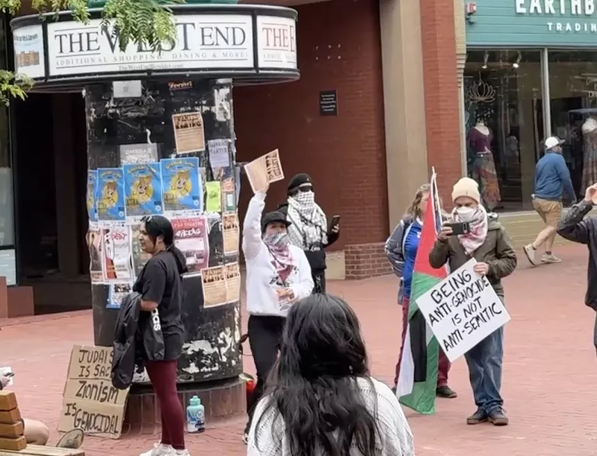 Pro-Palestinian protesters held signs a block away from the Boulder Jewish Festival