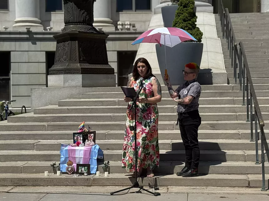 Woman in dress gives speech on steps
