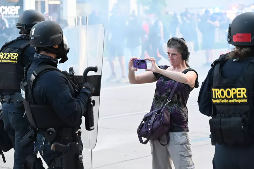 A woman films police.