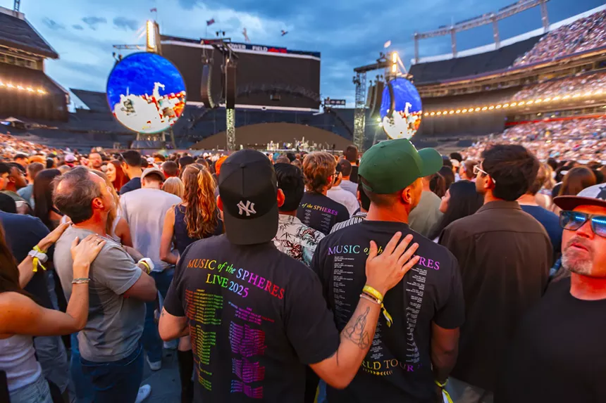 Coldplay fans wearing artist merch.