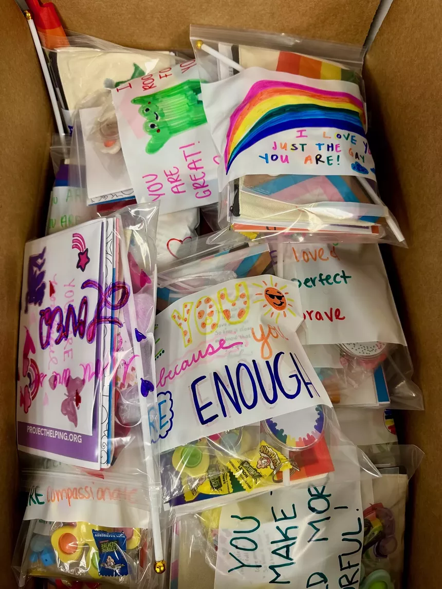 The interior of a Kynd Kit containing items for the LGBTQ+ community.